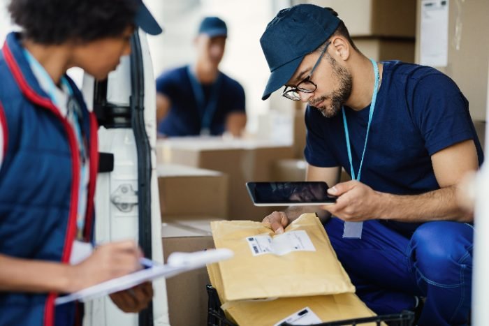 Logistics worker scanning packages for transportation support